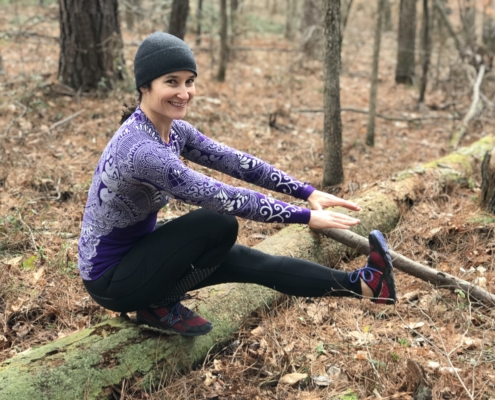 Betsy Petry-Johson glute strength. betsy in woods doing single leg exercise.