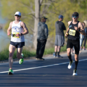 Zach Ripley racing at the bayshore marathon. You can see water and road behind the racers.